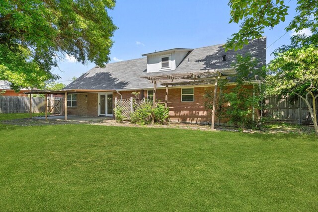 rear view of property with a fenced backyard, a pergola, a yard, and a patio