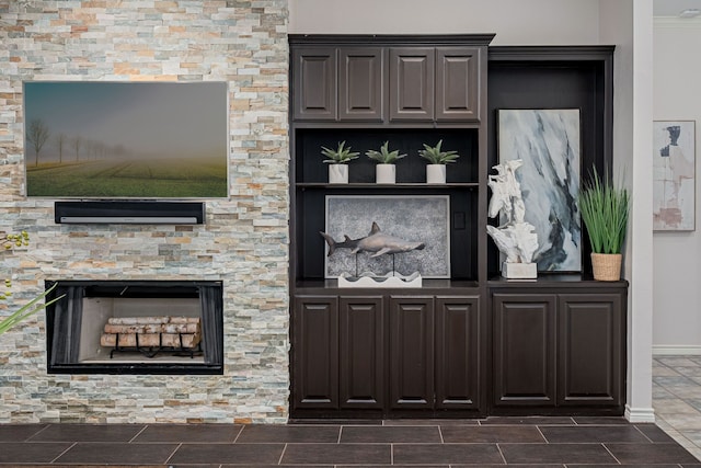 interior space featuring baseboards and a stone fireplace