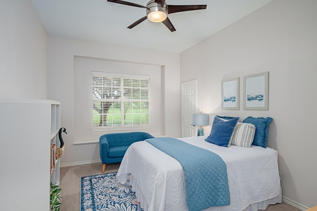 carpeted bedroom featuring baseboards and a ceiling fan