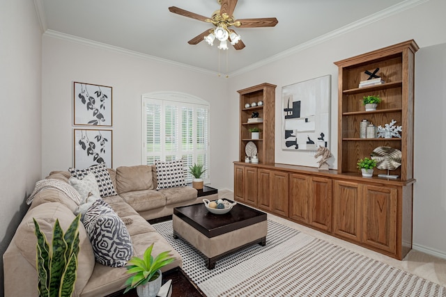 living area with a ceiling fan, baseboards, and ornamental molding