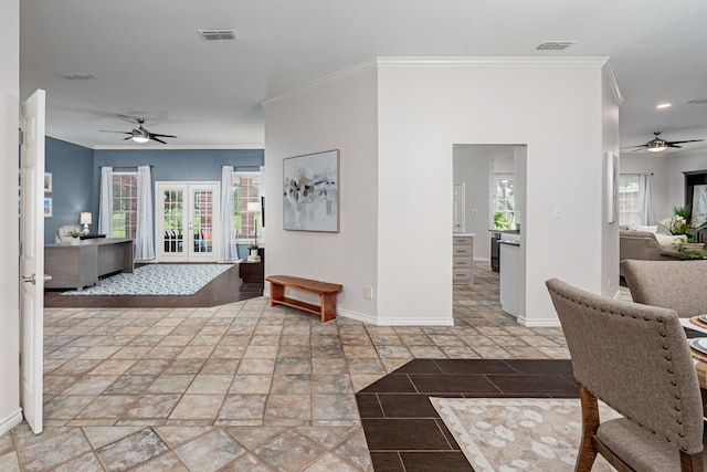 corridor with baseboards, ornamental molding, and visible vents