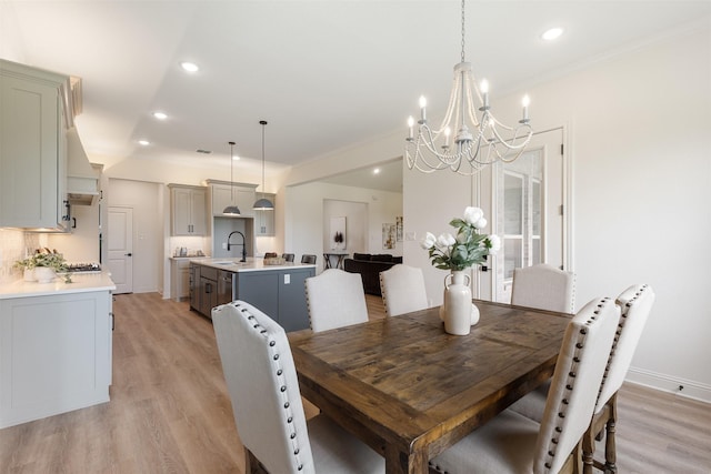 dining space with light wood-type flooring, recessed lighting, and a chandelier