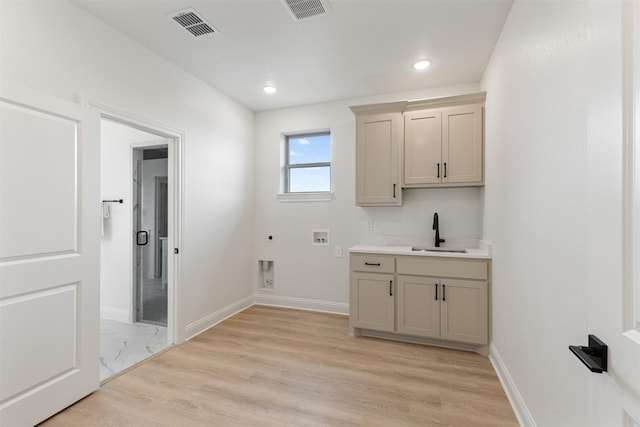 laundry area with a sink, washer hookup, hookup for an electric dryer, and visible vents