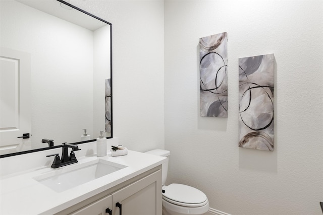 half bathroom with toilet and vanity