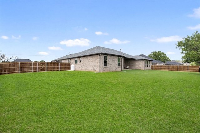 view of yard with a fenced backyard