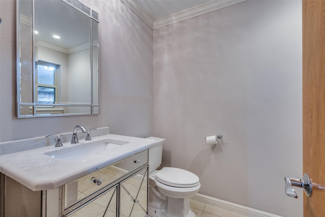 bathroom with tile patterned flooring, ornamental molding, toilet, baseboards, and a sink