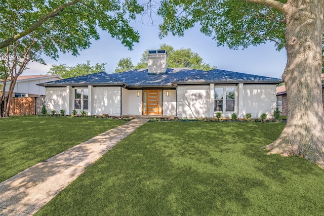 view of front of property featuring fence, a front yard, and a chimney