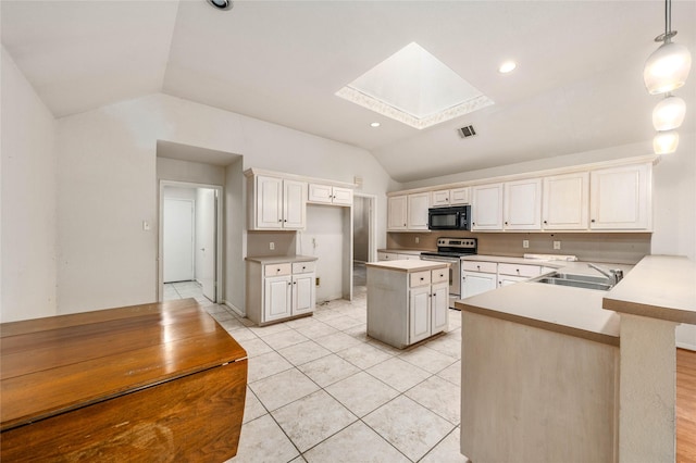 3133 Chimney Hill Dr, Waco, TX 76708 - kitchen with visible vents, black microwave, lofted ceiling with skylight, stainless steel electric range, and a sink
