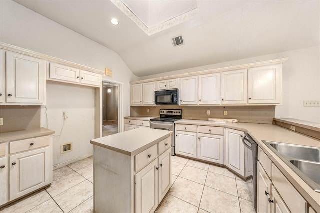 3133 Chimney Hill Dr, Waco, TX 76708 - kitchen with visible vents, lofted ceiling with skylight, light tile patterned floors, and stainless steel appliances