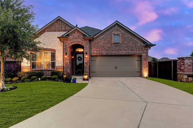 french provincial home featuring brick siding, concrete driveway, and an attached garage