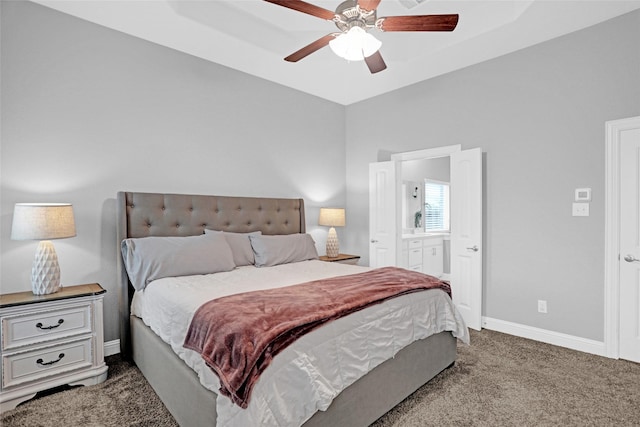 carpeted bedroom featuring baseboards, ensuite bathroom, and a ceiling fan