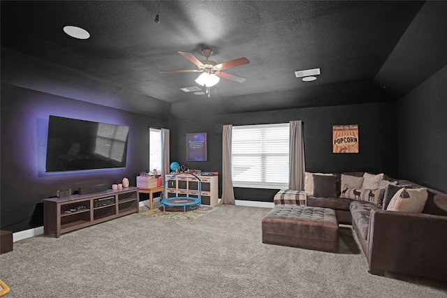 carpeted living room featuring ceiling fan, baseboards, a textured ceiling, and vaulted ceiling