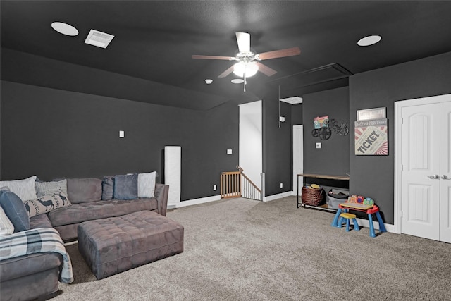 living room featuring attic access, carpet flooring, a ceiling fan, and baseboards