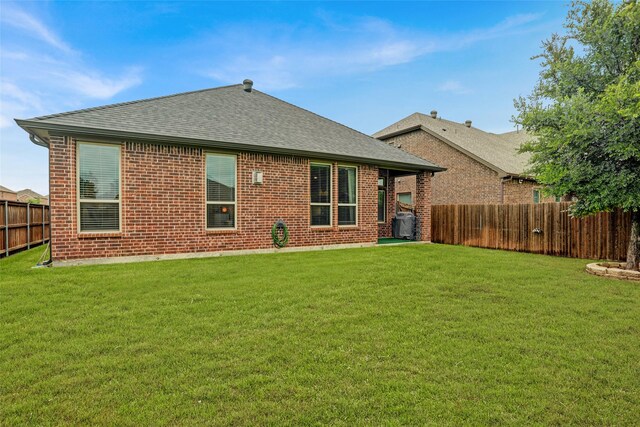 rear view of property with roof with shingles and brick siding