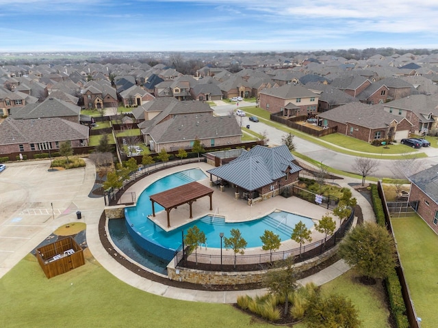 community pool with fence and a residential view