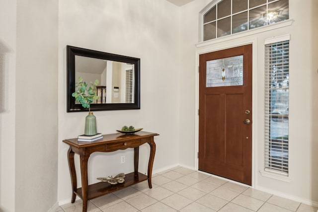 tiled foyer entrance featuring baseboards