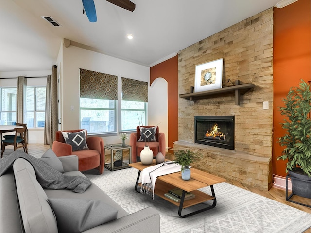 261 Chisholm Ranch Dr, Rockwall, TX 75032 - living room featuring visible vents, crown molding, wood finished floors, a fireplace, and a ceiling fan