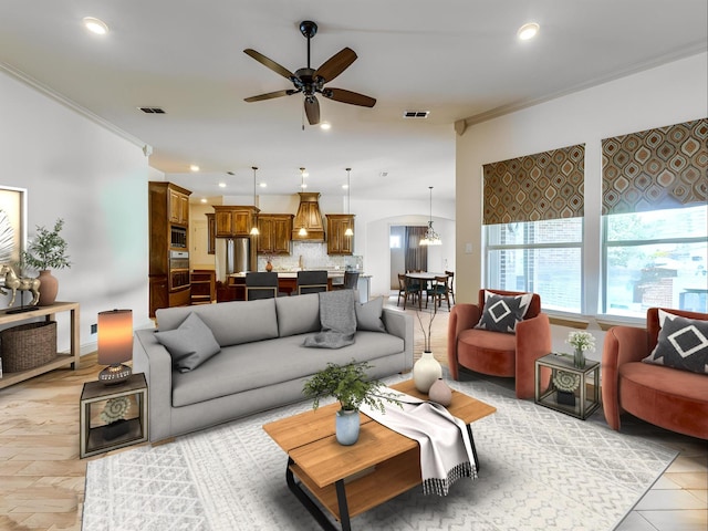 261 Chisholm Ranch Dr, Rockwall, TX 75032 - living room featuring crown molding, ceiling fan, and visible vents