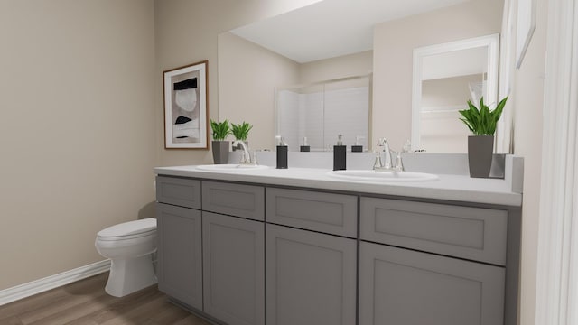 full bath featuring double vanity, toilet, a sink, and wood finished floors