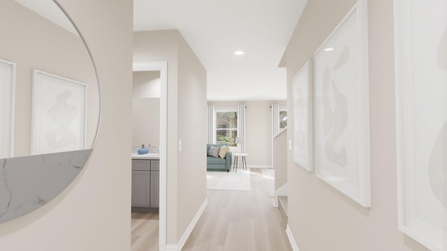 corridor with recessed lighting, baseboards, and light wood-type flooring