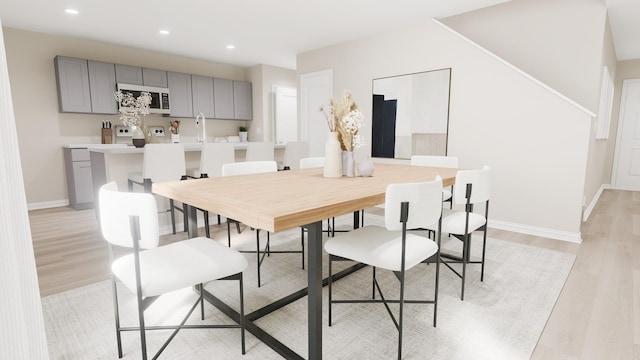 dining room with baseboards, recessed lighting, and light wood-style flooring