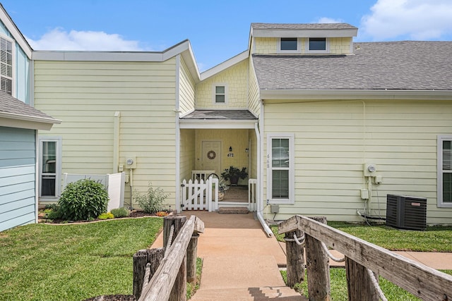 672 Harbor Dr, Azle, TX 76020 - entrance to property featuring central air condition unit, a lawn, and a shingled roof