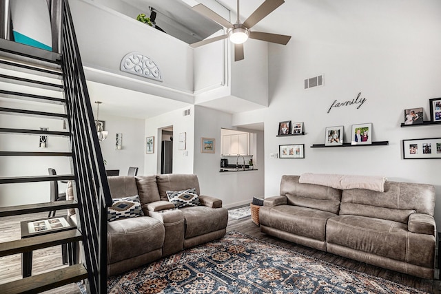 672 Harbor Dr, Azle, TX 76020 - living room featuring a towering ceiling, ceiling fan, baseboards, wood finished floors, and stairs