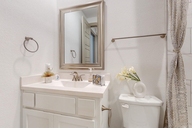 half bath featuring toilet and vanity