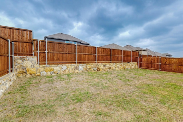 view of yard with a fenced backyard