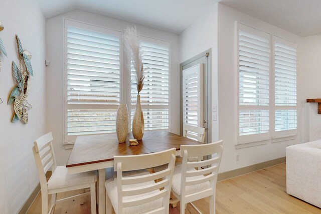 dining area with baseboards and wood finished floors