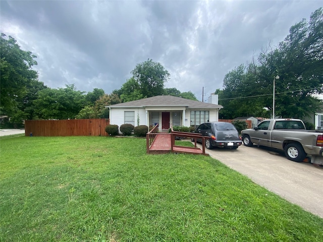 10721 Hermosa Dr, Dallas, TX 75218 - view of front of home with a chimney, fence, and a front yard