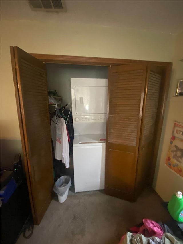 10721 Hermosa Dr, Dallas, TX 75218 - clothes washing area featuring stacked washer / drying machine, visible vents, and laundry area