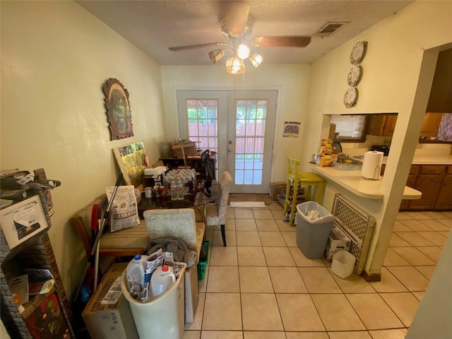 10721 Hermosa Dr, Dallas, TX 75218 - sitting room with visible vents, light tile patterned flooring, ceiling fan, a textured ceiling, and french doors
