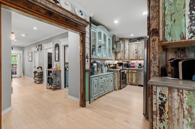 bar featuring appliances with stainless steel finishes, ornamental molding, light wood finished floors, and wall chimney exhaust hood