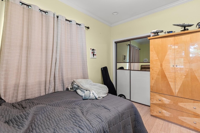 bedroom featuring crown molding and wood finished floors