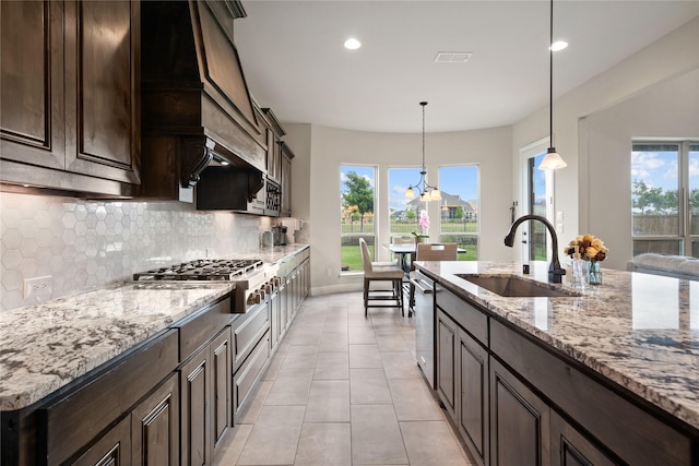 2308 Topaz Dr, Rockwall, TX 75087 - kitchen with visible vents, dark brown cabinetry, a sink, appliances with stainless steel finishes, and backsplash