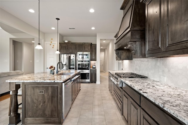 2308 Topaz Dr, Rockwall, TX 75087 - kitchen featuring dark brown cabinets, appliances with stainless steel finishes, a sink, and tasteful backsplash