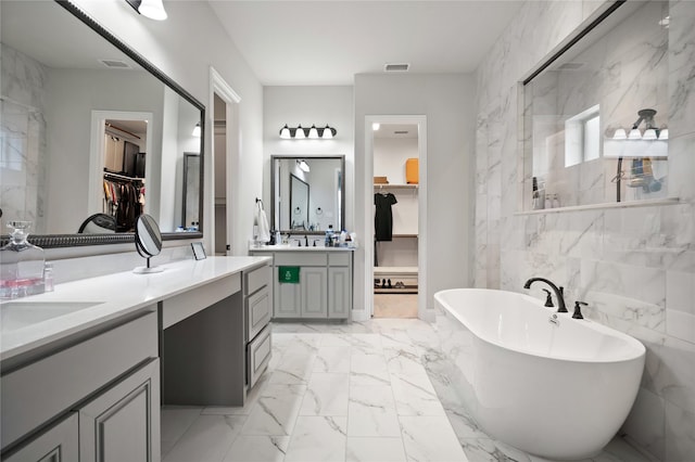 2308 Topaz Dr, Rockwall, TX 75087 - bathroom featuring a freestanding tub, a walk in closet, marble finish floor, and visible vents
