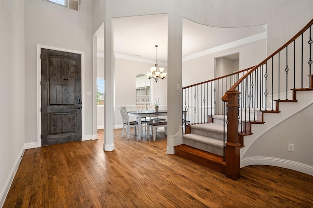 2308 Topaz Dr, Rockwall, TX 75087 - foyer entrance with visible vents, wood finished floors, baseboards, stairway, and a chandelier