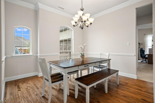 2308 Topaz Dr, Rockwall, TX 75087 - dining area with baseboards, an inviting chandelier, ornamental molding, and visible vents