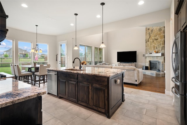 2308 Topaz Dr, Rockwall, TX 75087 - kitchen featuring a sink, dark brown cabinets, stainless steel appliances, and a healthy amount of sunlight