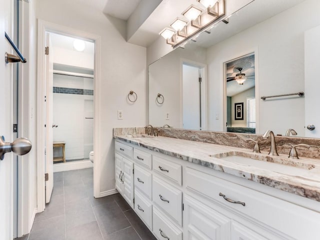full bath featuring tile patterned floors, toilet, a shower stall, double vanity, and a ceiling fan