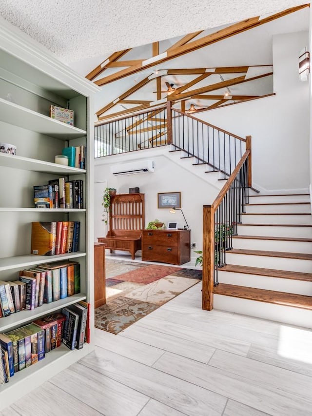 stairs featuring a wall mounted air conditioner