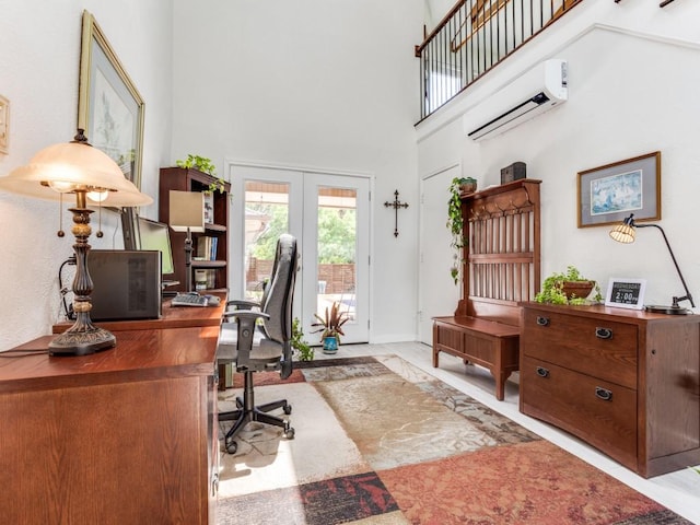 office space featuring a towering ceiling, a wall mounted air conditioner, french doors, marble finish flooring, and baseboards