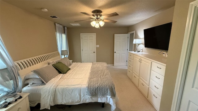 407 S Lakewood Cir, Lake Bridgeport, TX 76426 - bedroom with light colored carpet, a textured ceiling, and a ceiling fan