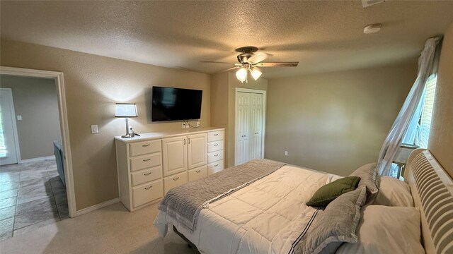 407 S Lakewood Cir, Lake Bridgeport, TX 76426 - bedroom featuring a textured ceiling, multiple windows, baseboards, a ceiling fan, and a closet