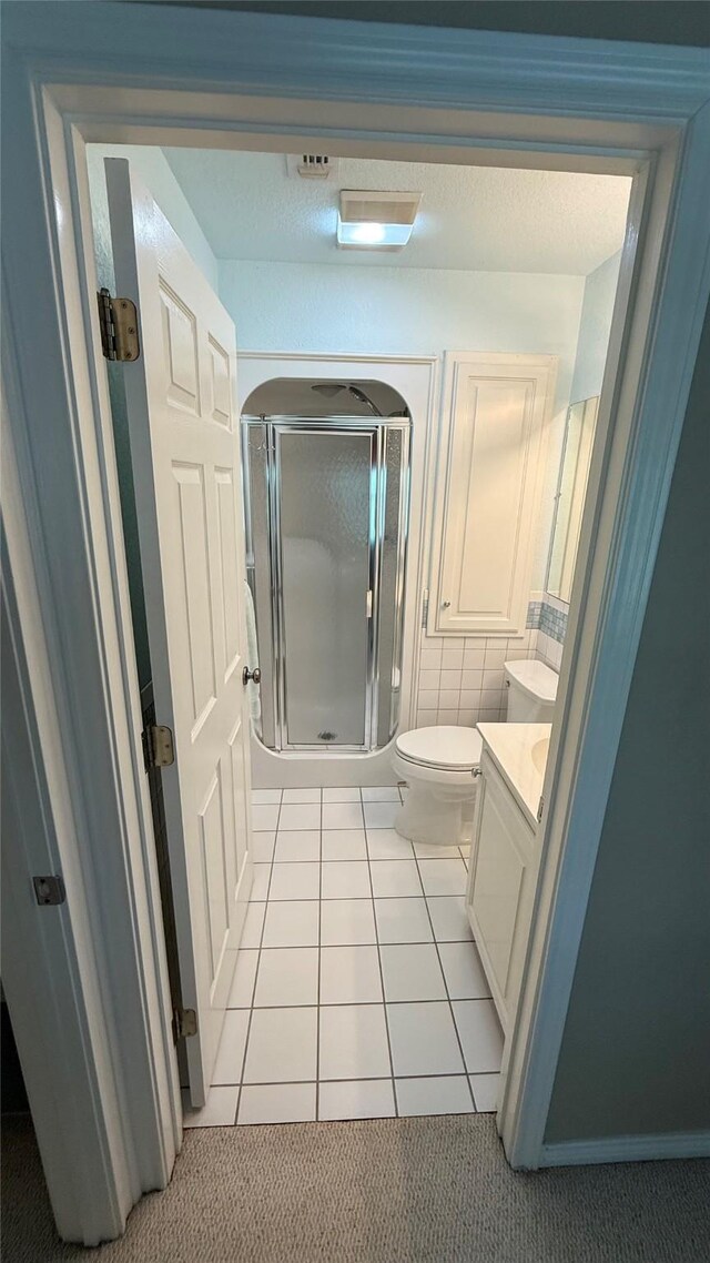 407 S Lakewood Cir, Lake Bridgeport, TX 76426 - full bath with a stall shower, tile patterned flooring, vanity, and toilet