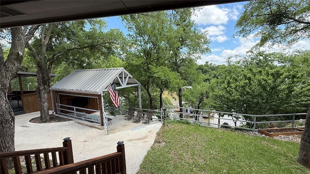 407 S Lakewood Cir, Lake Bridgeport, TX 76426 - view of yard with fence, a patio, an outdoor structure, and view of scattered trees