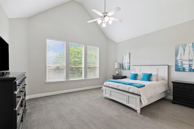 bedroom with baseboards, ceiling fan, light carpet, and high vaulted ceiling