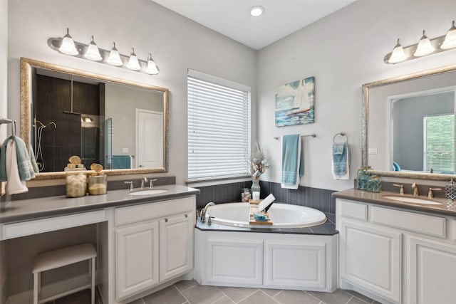 full bath with tile patterned flooring, a sink, a bath, and two vanities